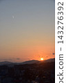 Takayama City, Gifu Prefecture, Japan: A townscape in the city center towards the three-story pagoda, with a beautiful sunset and a jet plane flying overhead. 143276392