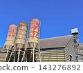 Rusty Silos And Works Tower Under Deep Blue Sky Rusty Silos And Works Tower Under Deep Blue Sky 143276892