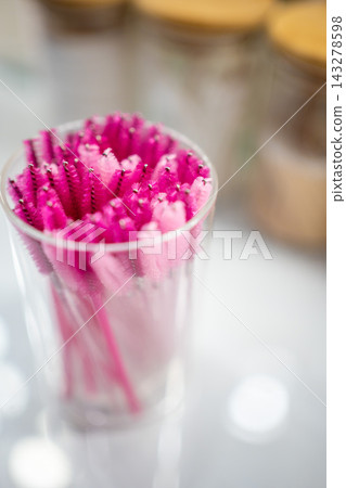 Pink eyelash brushes for eyelash extension in glass cup Pink eyelash brushes for eyelash extension in glass cup 143278598