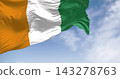 Ivory Coast national flag waving in the wind on a clear day 143278763