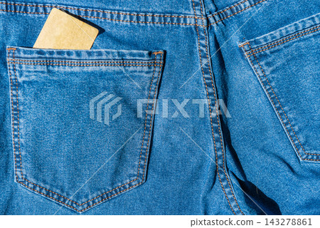 Plastic bank card in blue jeans pocket Plastic bank card in blue jeans pocket 143278861