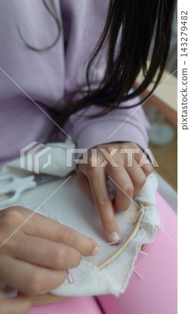Focused shot highlighting skilled tailors sewing with tools 143279482