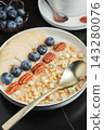 Oatmeal. Bowl of oatmeal porridge with blackberry, bananas and chia seeds on gray concrete old table background. Top view in flat lay style. Natural ingredients. Hot healthy breakfast and diet food 143280076