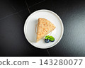 Medovik. Honey cake made from honey cakes with whipped sour cream, decorated with berries, pomegranate and flowers 143280077
