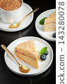Medovik. Honey cake made from honey cakes with whipped sour cream, decorated with berries, pomegranate and flowers 143280078