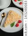 Sliced Napoleon cake on a white wooden table. Classic dessert 143280083