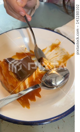 Delicious desserts with reflective silverware and warm ambiance Delicious desserts with reflective silverware and warm ambiance 143280102