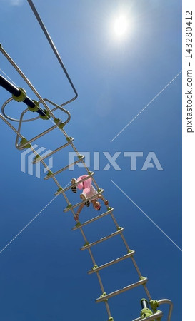 Caucasian female athlete engaging in intense suspension exercise outdoors Caucasian female athlete engaging in intense suspension exercise outdoors 143280412