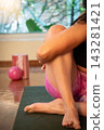 Woman practicing yoga on mat with equipment 143281421