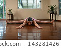 Woman practicing yoga wide angle seated forward bend 143281426