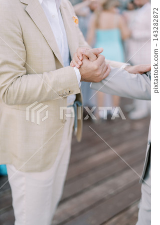 Close-up handshake between two men in suits Close-up handshake between two men in suits 143282872
