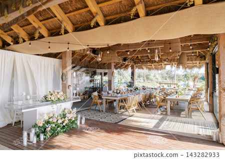 Elegant rustic wedding setup with natural sunlight and festive ambiance 143282933