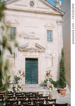 Outdoor wedding ceremony setup at historic church in Perast Outdoor wedding ceremony setup at historic church in Perast 143282940