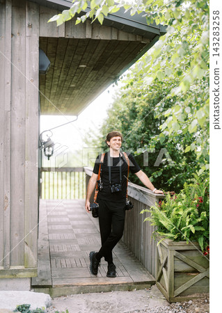 Male Wedding Photographer Carrying Four Cameras Outdoors Male Wedding Photographer Carrying Four Cameras Outdoors 143283258