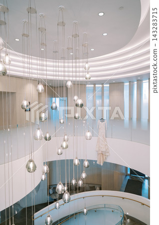 Elegant wedding dress displayed in modern spiral staircase 143283715
