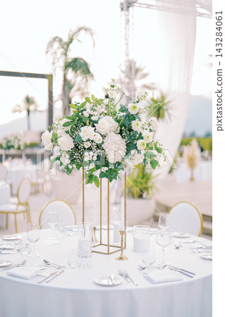 Elegant white floral wedding centerpiece outdoors Elegant white floral wedding centerpiece outdoors 143284061