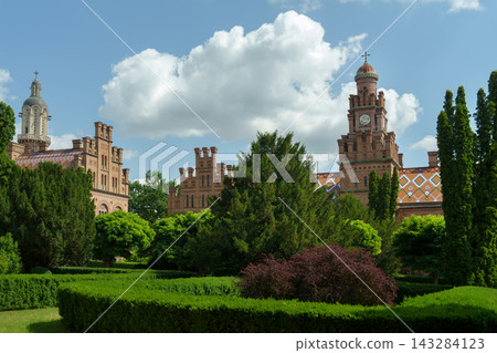 Chernivtsi National University palace and clock tower with beautiful formal garden. 143284123
