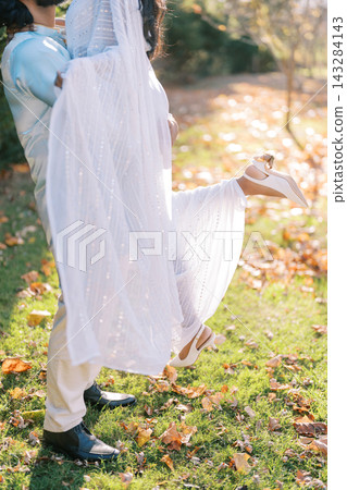 Romantic Outdoor Moment with Couple in Traditional Attire 143284143