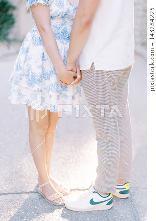 Couple Holding Hands Outdoors in Summer Light Couple Holding Hands Outdoors in Summer Light 143284225