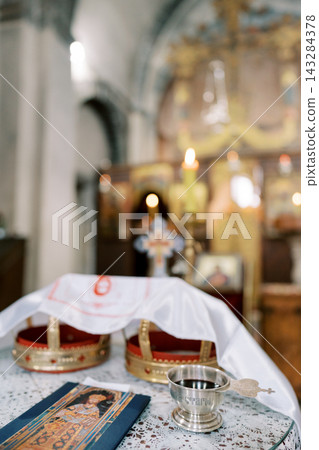 Orthodox wedding crowns and ritual items in church 143284378