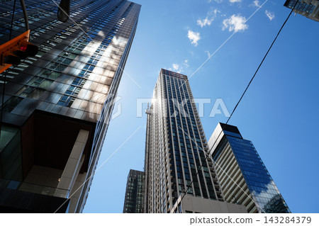 Modern skyscrapers against clear blue sky 143284379
