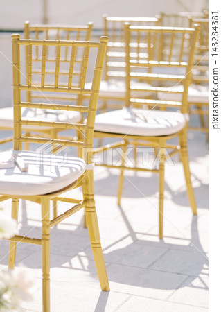 Elegant gold chairs arranged for wedding ceremony Elegant gold chairs arranged for wedding ceremony 143284381