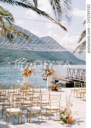 Elegant seaside wedding ceremony setup in Montenegro Elegant seaside wedding ceremony setup in Montenegro 143284382