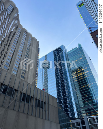 Toronto, Canada - September 25, 2025: Urban horizon displays gleaming glass structures. Metropolitan view highlights iconic tower Toronto, Canada - September 25, 2025: Urban horizon displays gleaming glass structures. Metropolitan view highlights iconic tower 143284607