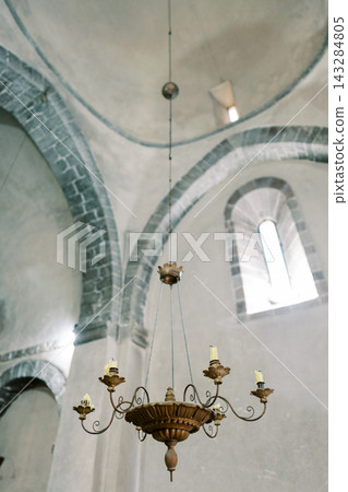 Elegant historic lighting. Ceiling arches and ornate fixtures create timeless sanctuary of beauty and history Elegant historic lighting. Ceiling arches and ornate fixtures create timeless sanctuary of beauty and history 143284805