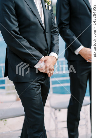 Groomsmen Standing at Outdoor Wedding Ceremony Groomsmen Standing at Outdoor Wedding Ceremony 143284958