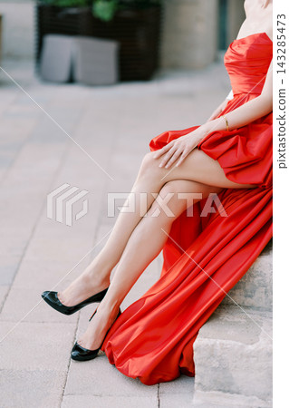 Two elegantly dressed women posed on stone pavement highlighting luxurious fashion details Two elegantly dressed women posed on stone pavement highlighting luxurious fashion details 143285473