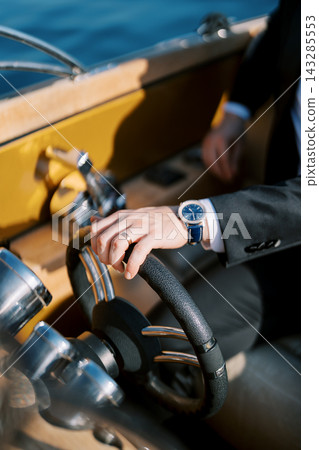 Professional individual with vintage steering wheel and sophisticated surroundings Professional individual with vintage steering wheel and sophisticated surroundings 143285553