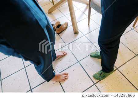 Casual And Natural Moment Captured Of Two Persons In Sunny Domestic Kitchen Setting 143285660