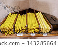 Handcrafted Beeswax Candles On Wooden Shelf. Closeup Of Organic Beeswax Candles With Tags 143285664