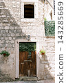 Historic Stone Passage Way. Quiet Corridor Lined With Aged Wood And Lush Ivy Covering Walls 143285669