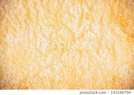 Warm golden orange textured background with mottled plaster surface and softly distressed tonal variation for decorative backdrop and graphic design composition Warm golden orange textured background with mottled plaster surface and softly distressed tonal variation for decorative backdrop and graphic design composition 143286704