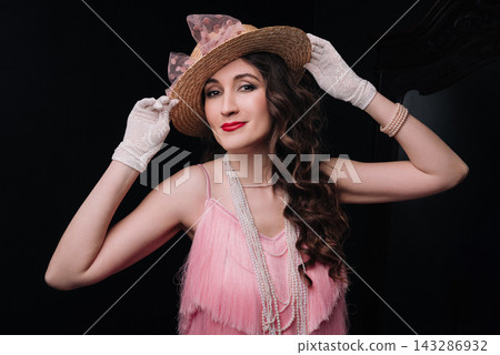 Elegant young woman and girl in pink fringe dress and straw boater hat Elegant young woman and girl in pink fringe dress and straw boater hat 143286932