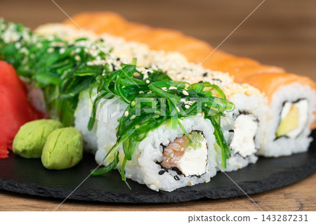 delicious traditional Japanese sushi and rolls on a plate delicious traditional Japanese sushi and rolls on a plate 143287231