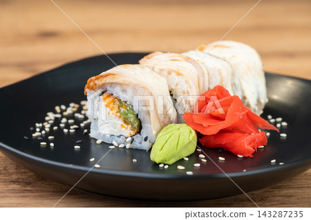 delicious traditional Japanese sushi and rolls on a plate delicious traditional Japanese sushi and rolls on a plate 143287235