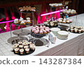 Assorted mini desserts and mousse cakes on a banquet table 143287384