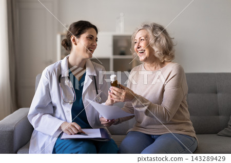 Doctor prescribing pills giving meds bottle to senior woman patient Doctor prescribing pills giving meds bottle to senior woman patient 143289429