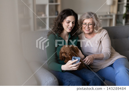 Family cuddle dog on couch use smartphone Family cuddle dog on couch use smartphone 143289484