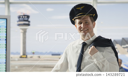 Airline captain in uniform walking through busy airport terminal with suitcase, preparing for flight. Professional pilot embody aviation career, reliable service within cabin crew operations. Airline captain in uniform walking through busy airport terminal with suitcase, preparing for flight. Professional pilot embody aviation career, reliable service within cabin crew operations. 143289721