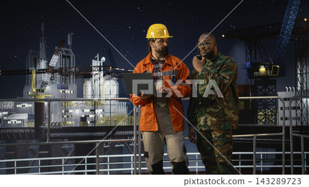 Enforcing maritime blockade protocols, walkie talkie and military man on drilling rig. Talking, handheld radio and soldier on offshore platform receives updates on war causing oil crisis, camera A 143289723