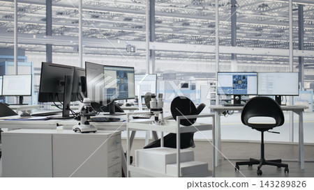Empty semiconductor engineering office with computers used to analyze microchip architecture systems. Research workspace with digital screens used to develop PCBs for electronics devices, camera A 143289826