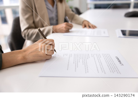 Closeup female professional confirming collaboration by signing contract with partner Closeup female professional confirming collaboration by signing contract with partner 143290174