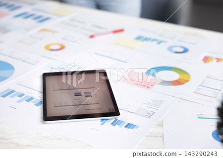 Close up view professional workspace filled with analytical reports papers Close up view professional workspace filled with analytical reports papers 143290243