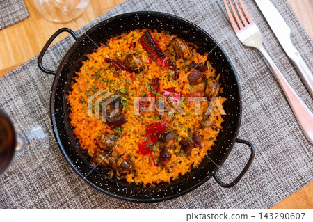 Traditional Valencian rice paella with snails Traditional Valencian rice paella with snails 143290607
