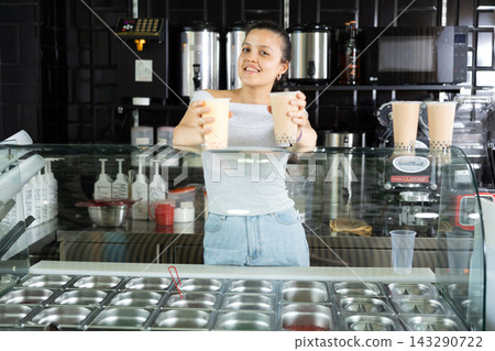Girl supermarket employee offers to drink bubble tea Girl supermarket employee offers to drink bubble tea 143290722