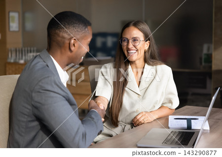 Manager shaking hands with client in company office Manager shaking hands with client in company office 143290877